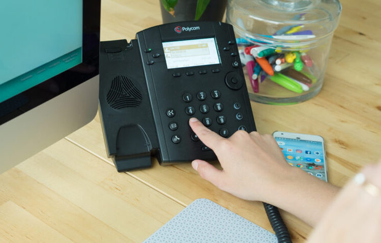 business phone service in an office being installed by Agilis Networks a telecommunication provider