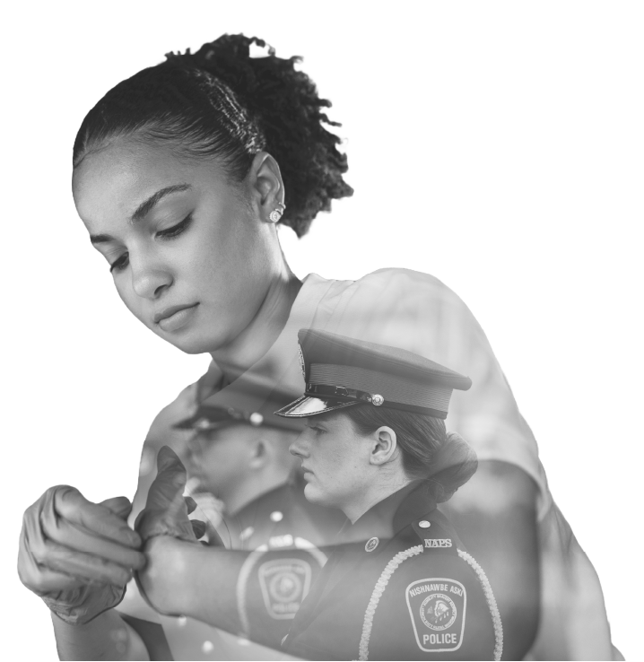 officer putting on gloves and another standing in uniform