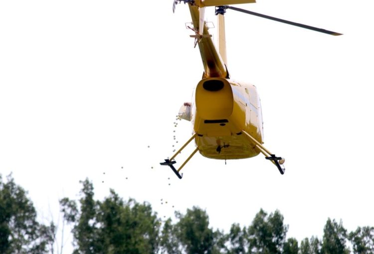 A helicopter hovers over a golf course